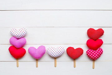 Valentine's hearts on white wooden background.