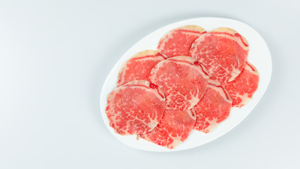 raw beef on a plate .
