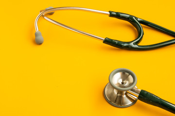 stethoscope on orange background.Flat lay and copy space. Medical Concept