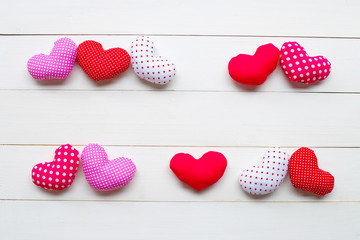 Valentine's hearts on white wooden background.