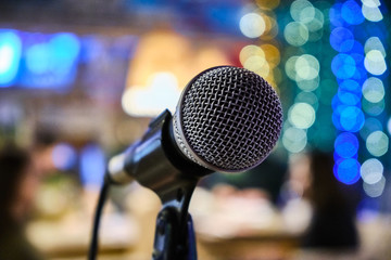 microphone on a stand up comedy stage with colorful bokeh , high contrast image