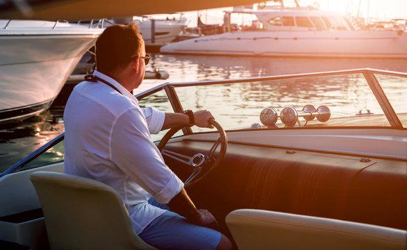 Young Man On Sailing Yacht. Hands Hold Steering Wheel