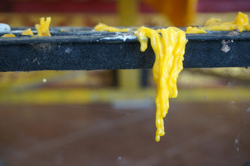 melted candles surface on grunge table in Buddhist temple