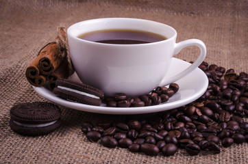Coffee in a white cup with tasty cookies