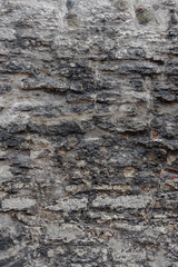 Fragment of old gray brick stone wall background