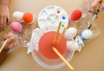 Happy Easter Day. Easter eggs concept. A girl hand painting Easter eggs. Happy family preparing for Easter.