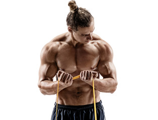 Athletic man performing exercises with a resistance band. Photo of strong man shirtless isolated on white background. Strength and motivation.