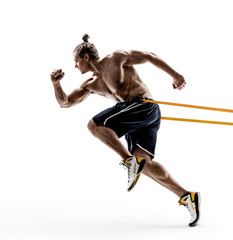 Sporty man runner in silhouette using a resistance band in his exercise routine. Photo of shirtless young man isolated on white background. Dynamic movement. Side view. Full length