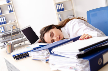 Young female employee unhappy with excessive work 