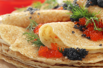 Russian pancakes with red and black caviar	
