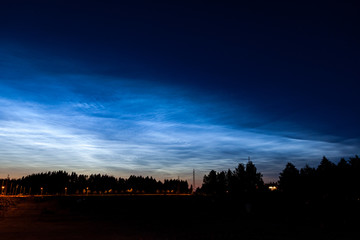 Noctilucent clouds glowing at night sky