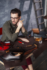 shoemaker thining about holidays, man looking forward of vacation, close up side view photo
