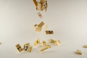 Falling dominoes on white background in slowmotion