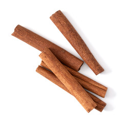Cinnamon sticks isolated on white background closeup. Canella spice. Aromatic condiment background. Flat lay, top view.