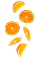 falling fresh orange fruit slices isolated on white background closeup. Flying food concept.