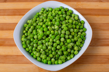 Freshly cooked green peas served in dish.