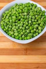 Freshly cooked green peas served in dish.