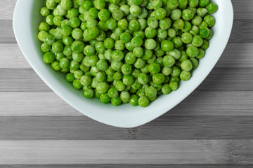 Freshly cooked green peas served in dish.