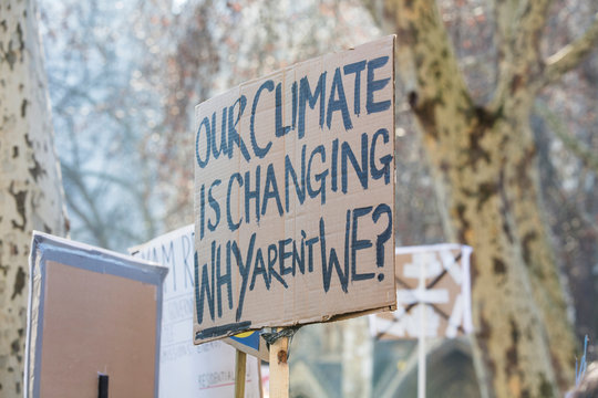 Protestors holding climate change banners at a protest