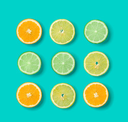 Obraz premium Citrus Fruit pattern on blue background. Orange, Lime, Lemon slices background. Flat lay, top view. . Pop art design, creative summer concept.