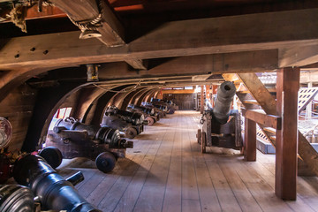 On the gun deck of an old pirate ship moored in the port of Genoa, Italy