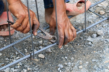 Construction technicians are working on steel, concrete building structures.