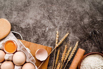 Baking ingredients on dark background with copyspace