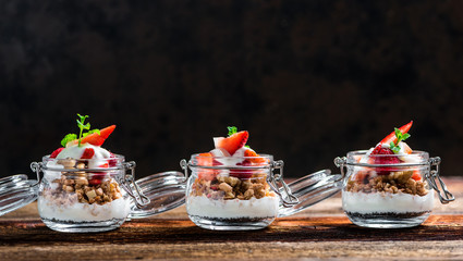 Delicious home-made muesli with yoghurt and fresh berries, beautifully presented in a mason jar to take away on the go