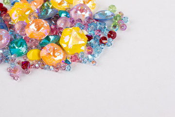 Gemstones crystals for jewelry scattered on white background
