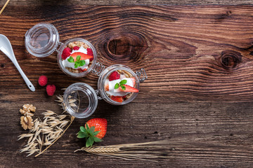 Delicious home-made muesli with yoghurt and fresh berries, beautifully presented in a mason jar to take away on the go