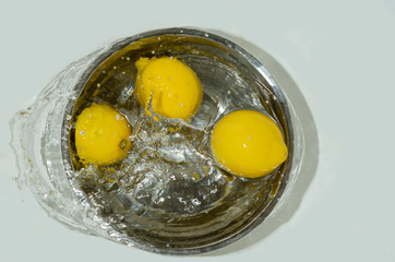 washing lemon in a bowl of water