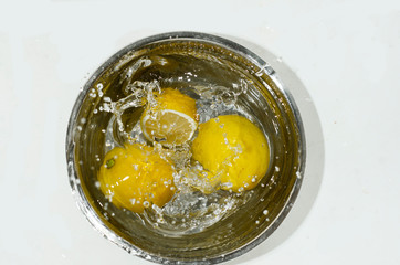 washing lemon in a bowl of water