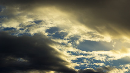 Naklejka na ściany i meble dark moody cloud scene with sun shining through