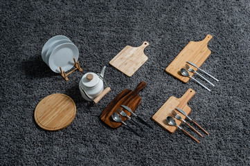Various kinds of kitchen tools on the grey carpet.