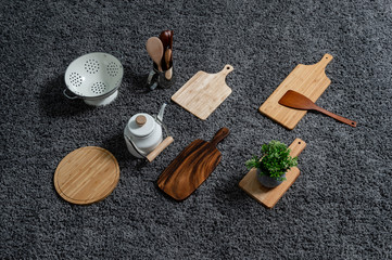 Various kinds of kitchen tools on the grey carpet.