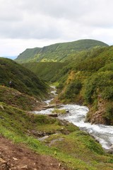 Fototapeta na wymiar Mountain Tahkoloch river flows in the caldera of the extinct Vchkazhets volcano on the Kamchatka Peninsula, Russia.