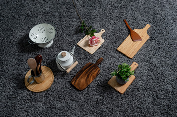 Various kinds of kitchen tools on the grey carpet.