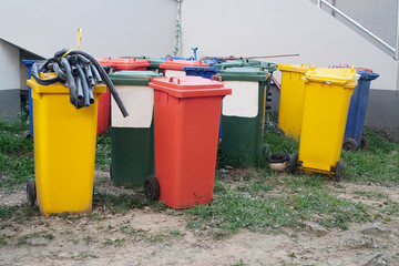 Colorful of trash can beside the walk way.