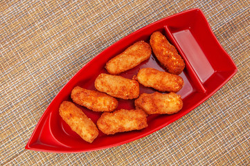 Fried breaded chicken on red graceful plate on japanese napkin