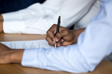 Black man putting signature affirm contract close up male hands