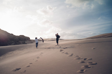 Two pretty women have fun in the dunes of Bologna, Andalucia Spain.