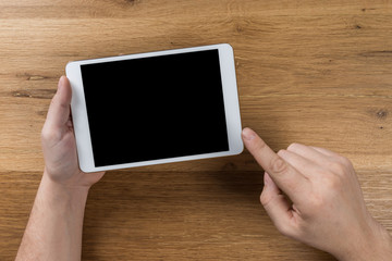 Man works using digital devices. Above view of desktop workspace.