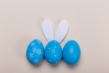 Blue easter eggs in nest on pastel color background with space. Concept