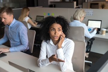 Black employee talking with client on phone solve problem distantly