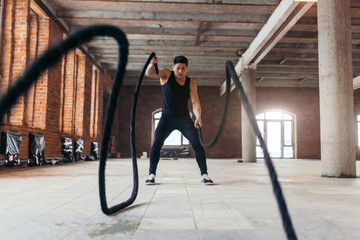 effective way to torch calories and enhance cardiovascular health. full length photo.battle rope session