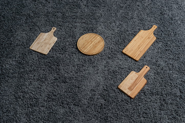 Various kinds of kitchen tools on the grey carpet.