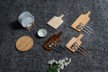 Various kinds of kitchen tools on the grey carpet.