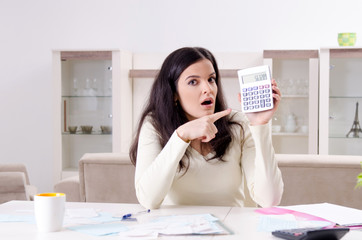 Young woman with receipts in budget planning concept 