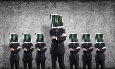 Businessmen with monitors instead of head.