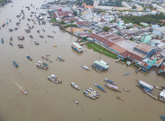 Panorama view traffic of Cai Rang floating market, Can Tho, Vietnam. Royalty stock photo image top view of tourists travel, people buy and sell food, vegetable, fruits on vessel, boat, ship on river